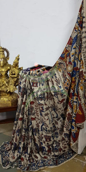 Off white handloom chennur silk kalamkari with village scene motif on body and peacock motif on pallu. The Saree comes with kalamkari printed blouse piece.