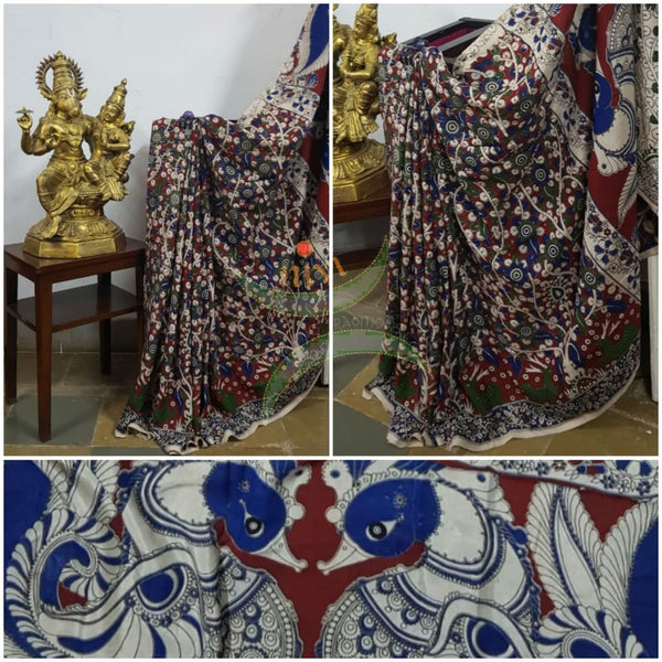 Maroon red handloom chennur silk kalamkari with floral motif on body and  peacock motif on pallu. Saree comes with kalamkari printed blouse piece.