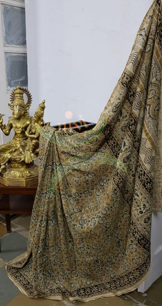 Mustard yellow handloom venkatagiri cotton kalamkari saree with all over floral motifs. The Saree comes with kalamkari printed blouse piece.