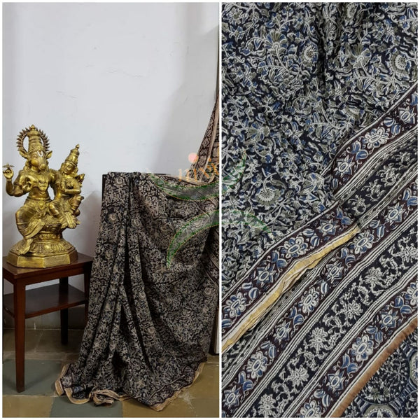Black shot with navy blue handloom venkatagiri cotton kalamkari saree with all over floral motifs. The Saree comes with kalamkari printed blouse piece.