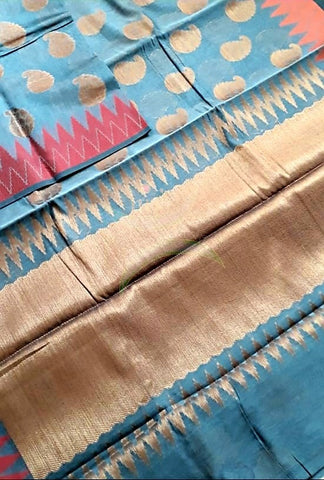 Teal blue cotton blended benaras brocade with ganga jamuna border and antique zari pallu and paisley motif on body. Saree comes with antique zari finished teal blue blouse.