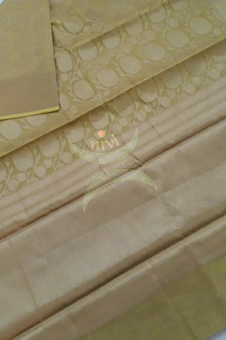 Matt gold colour silk cotton  Benares brocade with all over antique zari floral motif , pallu and border. Saree comes with blouse piece matching pallu