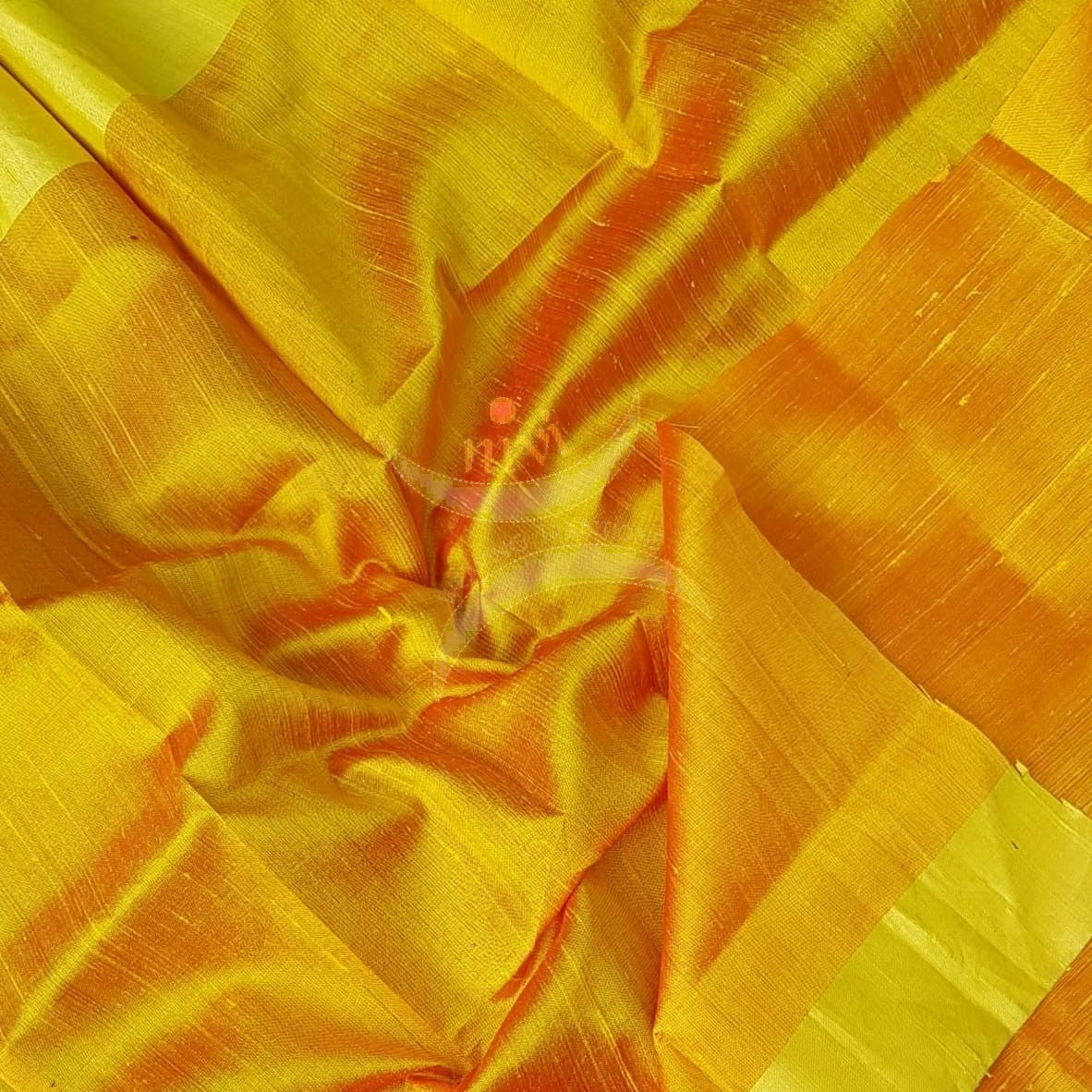 Golden orange handloom raw silk blouse piece with gold border.