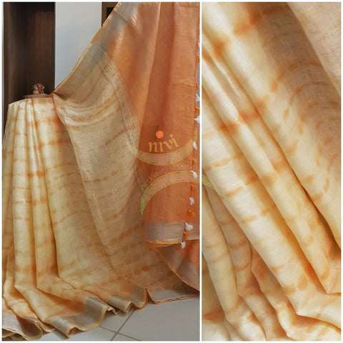 Handloom linen shibori with pom poms on pallu.