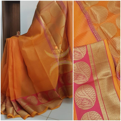 Orange shot pink silk cotton Benares brocade with antique gold zari motif on border and pallu.