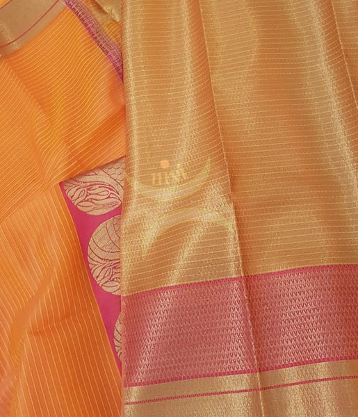 Orange shot pink silk cotton Benares brocade with antique gold zari motif on border and pallu.