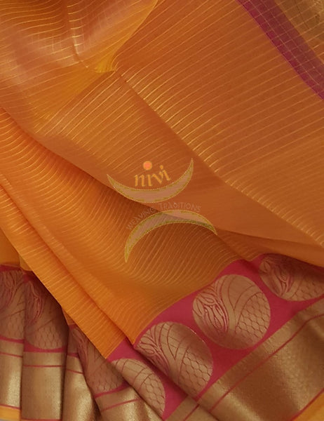 Orange shot pink silk cotton Benares brocade with antique gold zari motif on border and pallu.