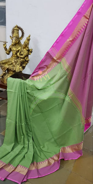 Pastel green handloom cotton soft drape with contrasting pink temple border, pallu and blouse.