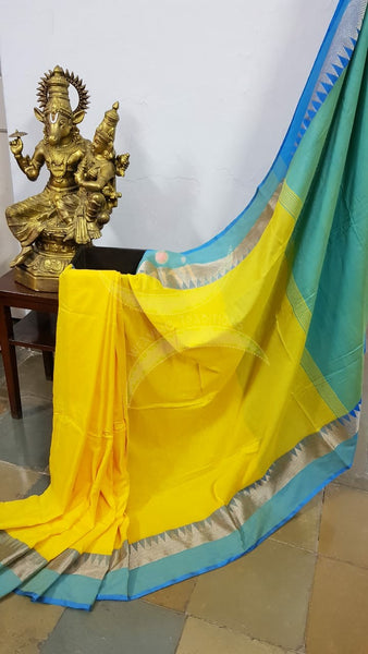 Yellow handloom cotton soft drape with contrasting sea blue temple border, pallu and blouse.