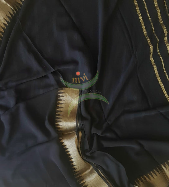 Black pure silk georgette with Matt gold temple border and striped pallu.