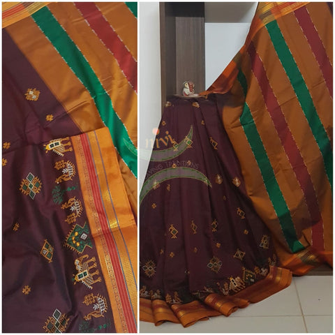 Maroon cotton blended ilkal with traditional anne ambari gopura motif kasuti embroidery and mustard tope teni pallu. Saree comes with running blouse.