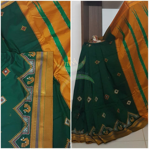 Green silk cotton ilkal with traditional peacock motif kasuti embroidery and mustard tope teni pallu. Saree comes with running blouse.
