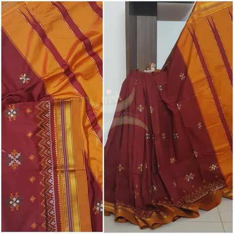Red silk cotton ilkal with traditional motif kasuti embroidery and mustard tope teni pallu. Saree comes with running blouse.