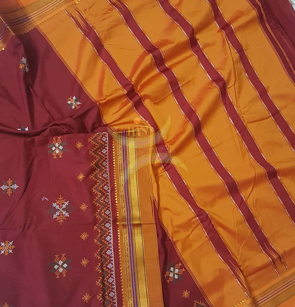 Red silk cotton ilkal with traditional motif kasuti embroidery and mustard tope teni pallu. Saree comes with running blouse.
