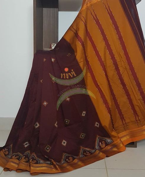 Maroon silk cotton ilkal with traditional peacock motif kasuti embroidery and mustard tope teni pallu. Saree comes with running blouse.