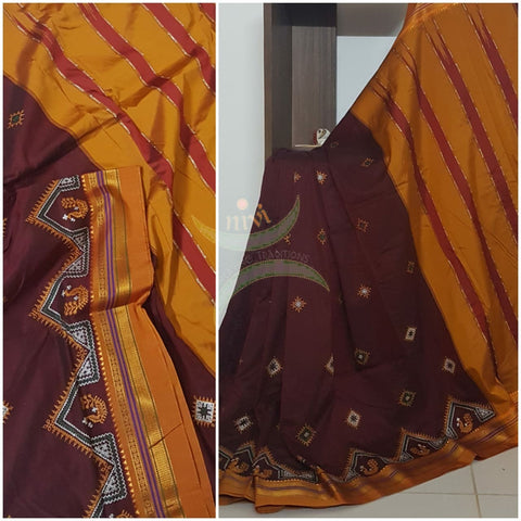 Maroon silk cotton ilkal with traditional peacock motif kasuti embroidery and mustard tope teni pallu. Saree comes with running blouse.
