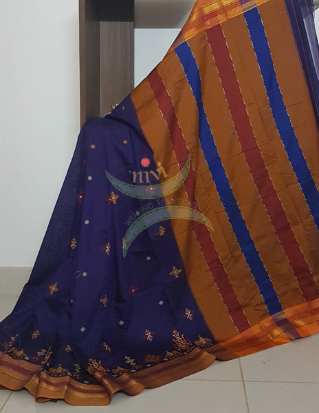 Royal blue cotton blended ilkal with traditional anne ambari motif kasuti embroidery and mustard tope teni pallu. Saree comes with running blouse.