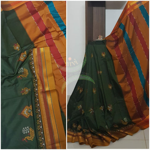 Mehendi green cotton blended  ilkal with traditional gopura motif kasuti embroidery and mustard tope teni pallu. Saree comes with running blouse.