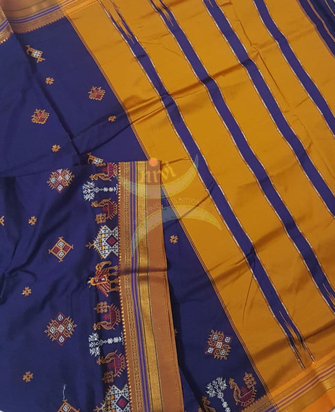 Royal blue silk cotton ilkal with traditional anne ambari gopura motif kasuti embroidery and mustard tope teni pallu. Saree comes with running blouse.