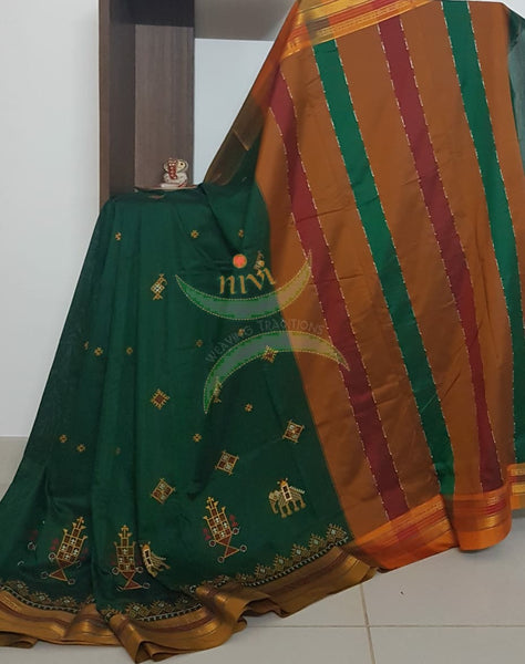 Green cotton blended ilkal with traditional anne ambari motif kasuti embroidery and mustard tope teni pallu. Saree comes with running blouse.