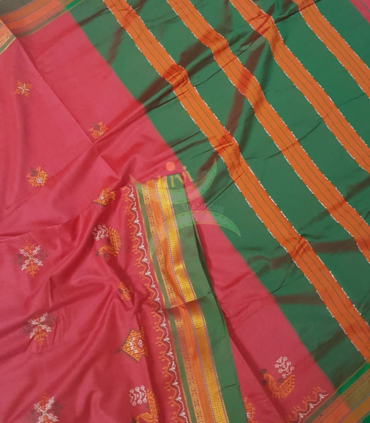 Red cotton blended ilkal with traditional gopura motif kasuti embroidery and green tope teni pallu. Saree comes with running blouse.