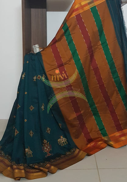 Teal cotton blended ilkal with traditional anne ambari motif kasuti embroidery and mustard tope teni pallu. Saree comes with running blouse.