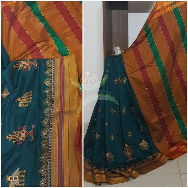 Teal cotton blended ilkal with traditional anne ambari motif kasuti embroidery and mustard tope teni pallu. Saree comes with running blouse.