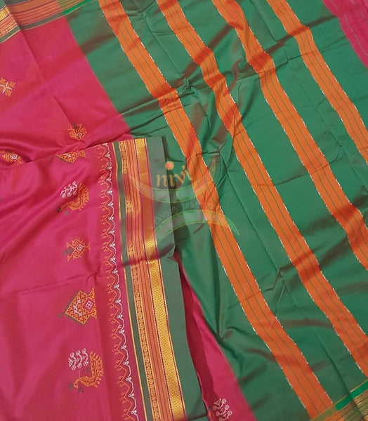 Pink cotton blended ilkal with traditional gopura motif kasuti embroidery and green tope teni pallu. Saree comes with running blouse.