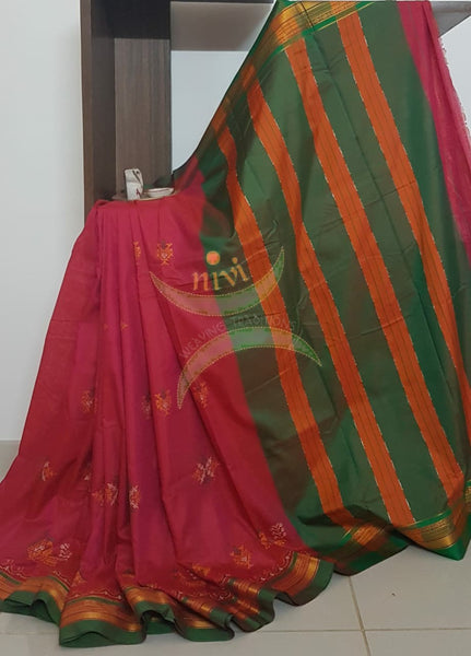 Pink cotton blended ilkal with traditional gopura motif kasuti embroidery and green tope teni pallu. Saree comes with running blouse.