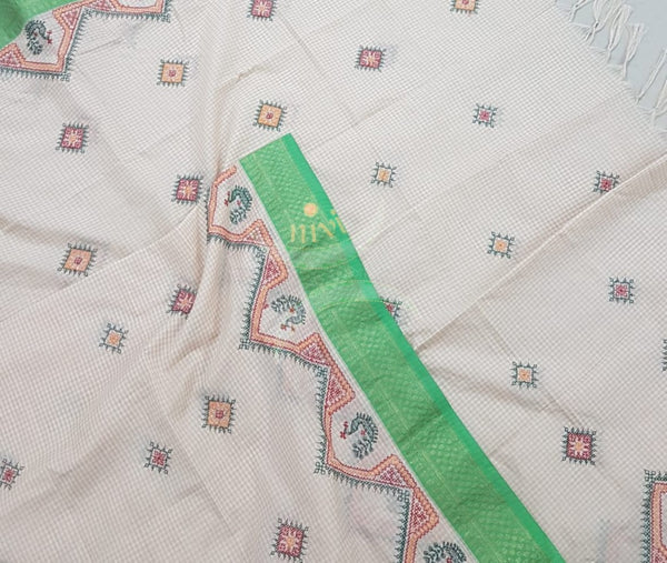 Off white chequared kota cotton dupatta with machine kasuti embroidery.