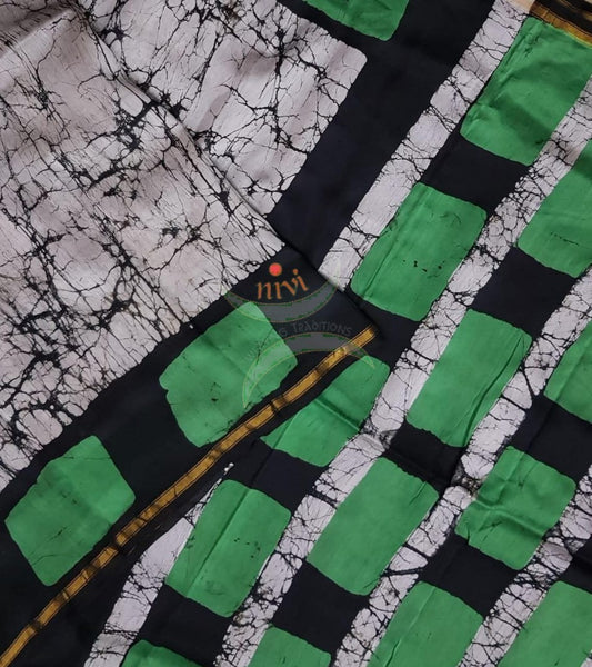 Handloom black and white with contrasting green Chanderi batik saree