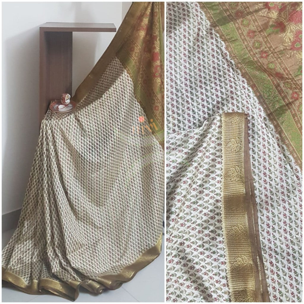 Beige printed art silk saree.  Saree comes with printed blouse piece 