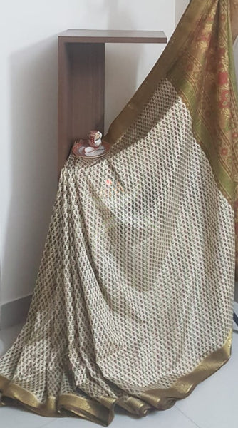 Beige printed art silk saree.  Saree comes with printed blouse piece 