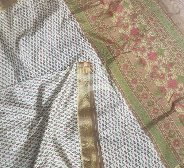 Beige printed art silk saree.  Saree comes with printed blouse piece 