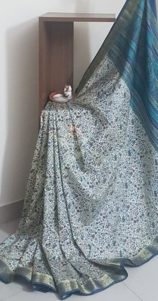 Beige printed art silk saree.  Saree comes with printed blouse piece 