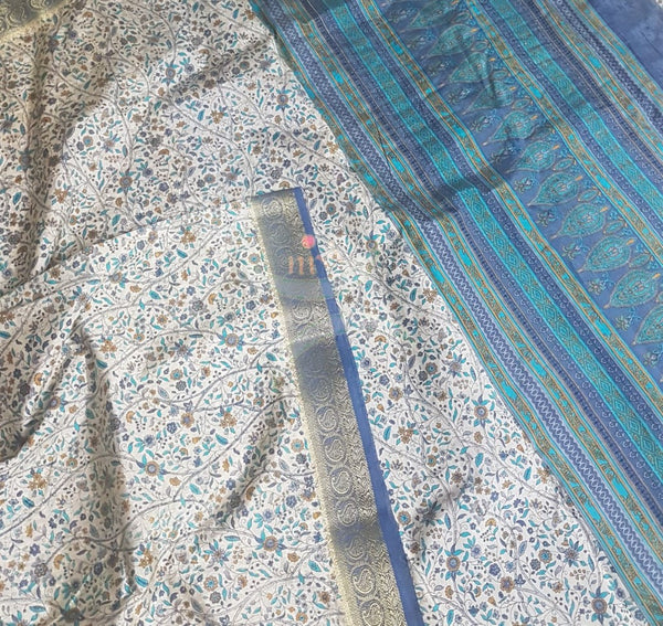 Beige printed art silk saree.  Saree comes with printed blouse piece 