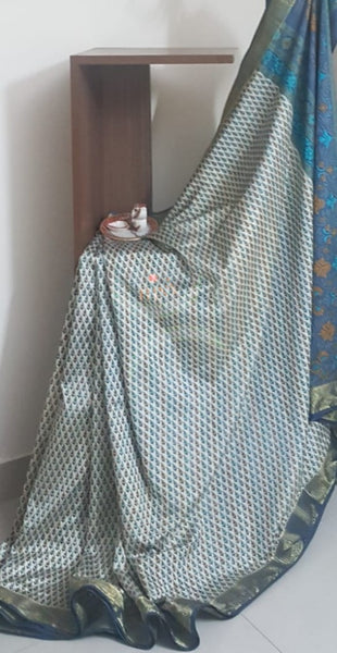 Beige printed art silk saree.  Saree comes with printed blouse piece 