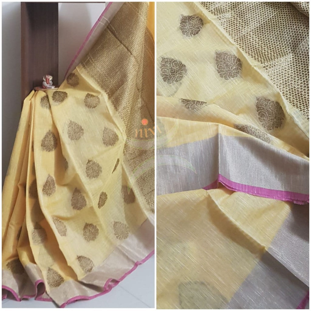 Yellow linen cotton benaras brocade with antique zari booties and brocade pallu. Saree is with tissue border.