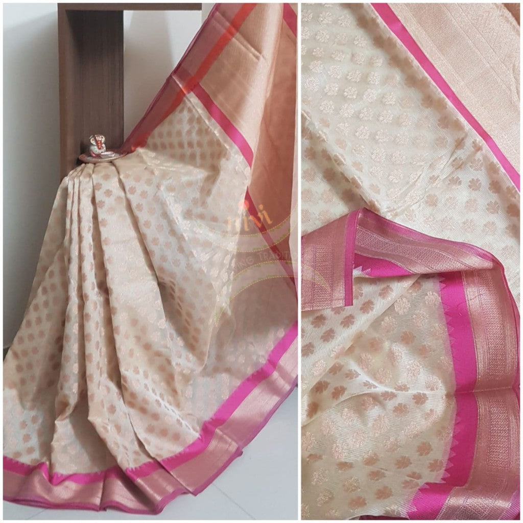 Off white silk cotton benaras brocade with ganga jamuna border and antique zari woven motifs. The saree comes with blouse piece matching saree body.