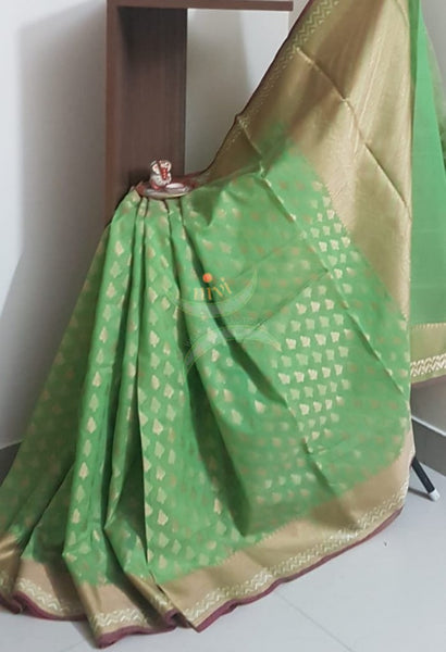 Green silk cotton benaras brocade with antique zari temple border. The saree comes with plain blouse matching body colour.