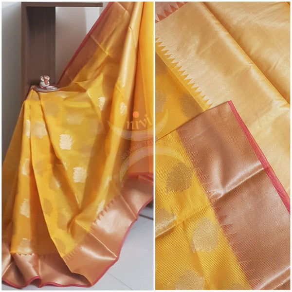 Turmeric yellow cotton blend benaras brocade with antique zari motif. The saree comes with matching yellow blouse piece.