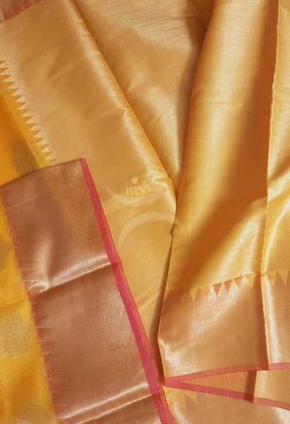 Turmeric yellow cotton blend benaras brocade with antique zari motif. The saree comes with matching yellow blouse piece.