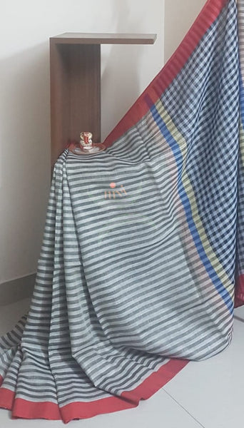 Grey horizontal striped linen saree with contrasting red border