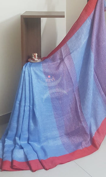 Blue linen saree with contrasting red border