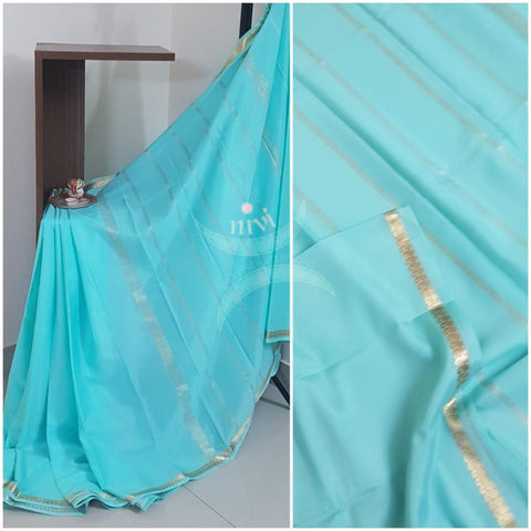Blue 50 gms pure Silk Crepe with paisley motif fine zari border. Saree comes with pure blue crepe blouse.