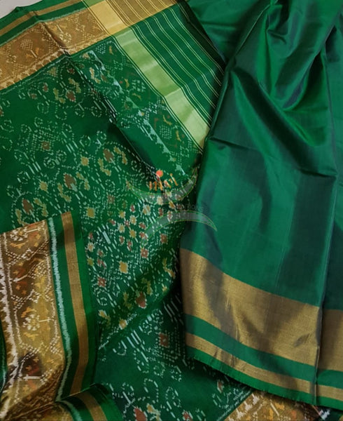 Green handloom patan patola silk saree with intricate woven pattern and subtle gold zari.