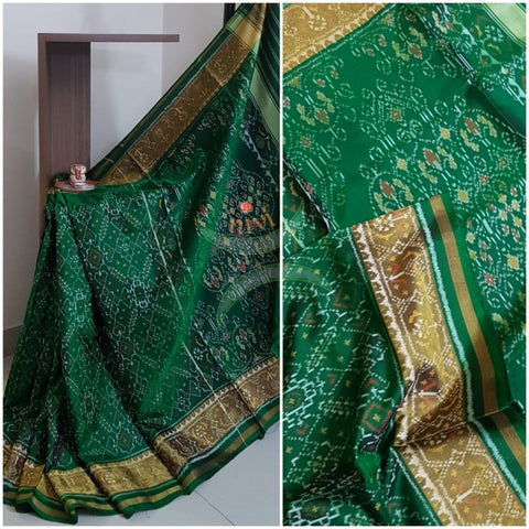 Green handloom patan patola silk saree with intricate woven pattern and subtle gold zari.