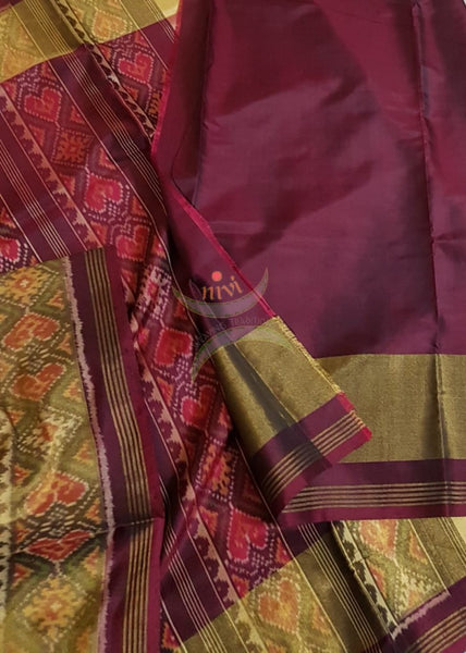 Red handloom patan patola silk saree with intricate woven pattern and subtle gold zari.