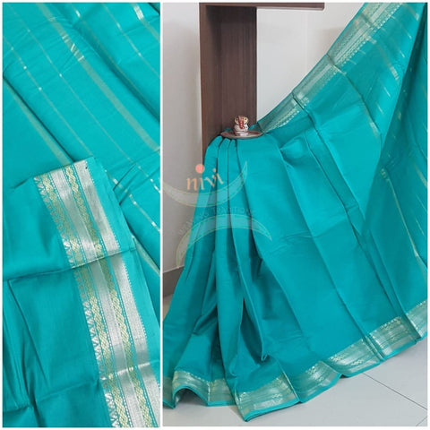 Sea green cotton blend saree with gold and silver zari border and striped pallu.