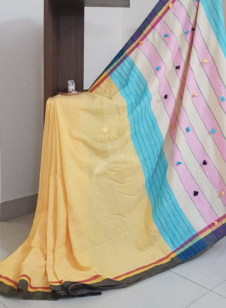 Yellow handloom cotton with contrasting black border, pompoms on pallu and running blouse.
